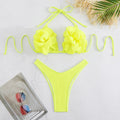 Low waist bikini swimsuit with 3D flower design in solid colour.