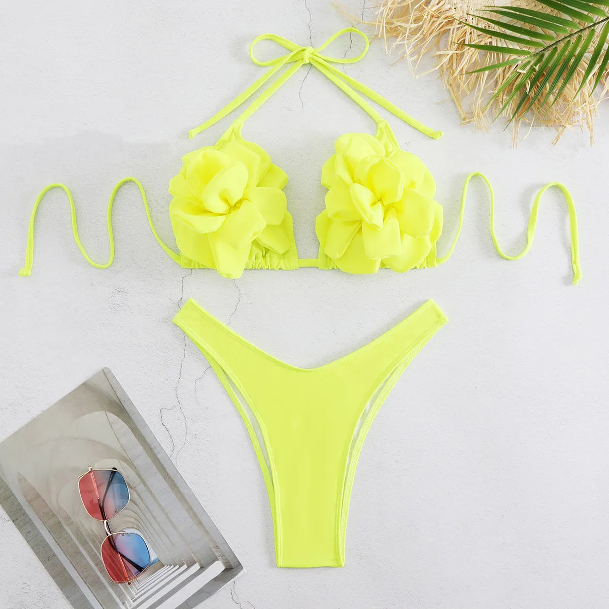 Low waist bikini swimsuit with 3D flower design in solid colour.