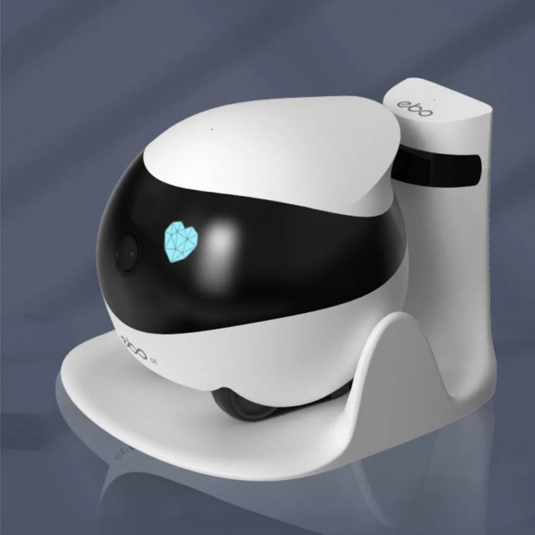 White smart home mobile surveillance robot camera on a docking station.