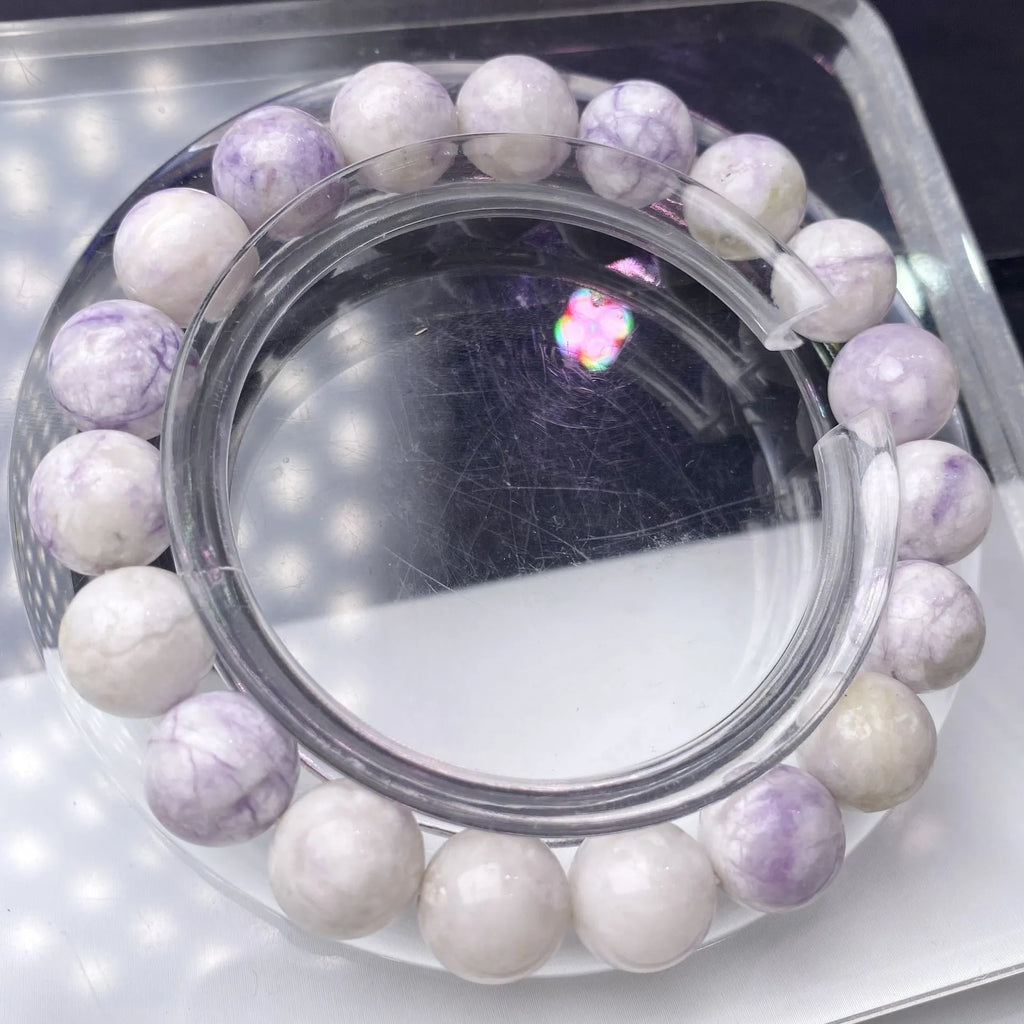 Close-up of a women's bracelet with natural purple turquoise beads on a wrist.