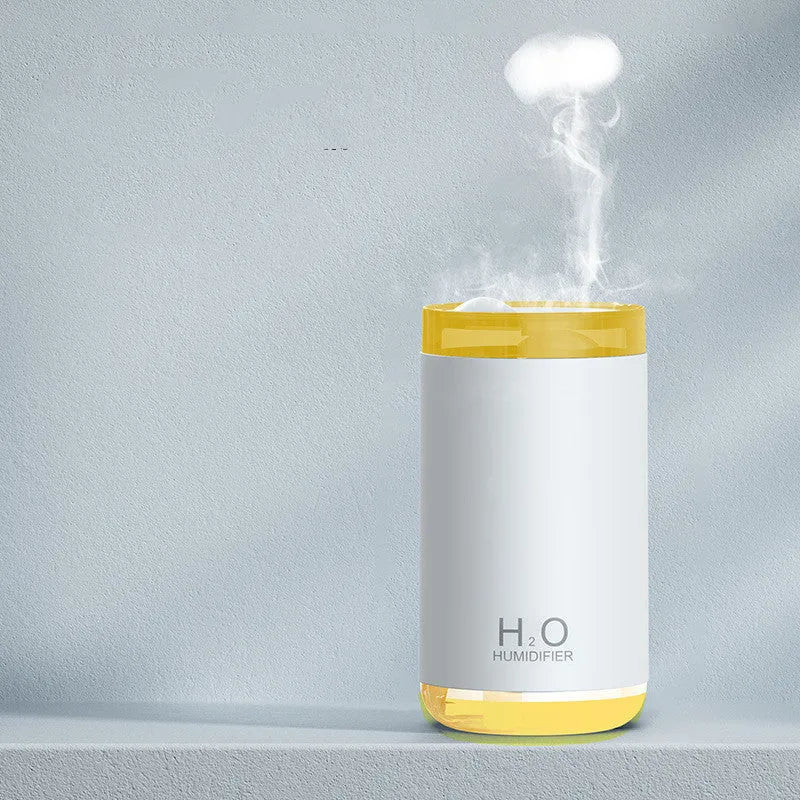 White USB jellyfish smoke ring humidifier with warm night light on a wooden desk