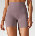 Women's high waist fitness tights in dark green, hip-length cut, for running and gym wear.