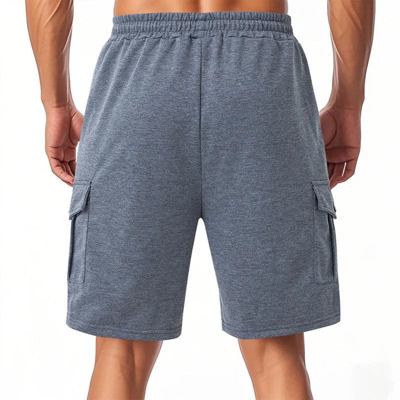 Men's heavy grey terry cloth cargo shorts with multiple pockets, shown in a loose fit for summer sports.