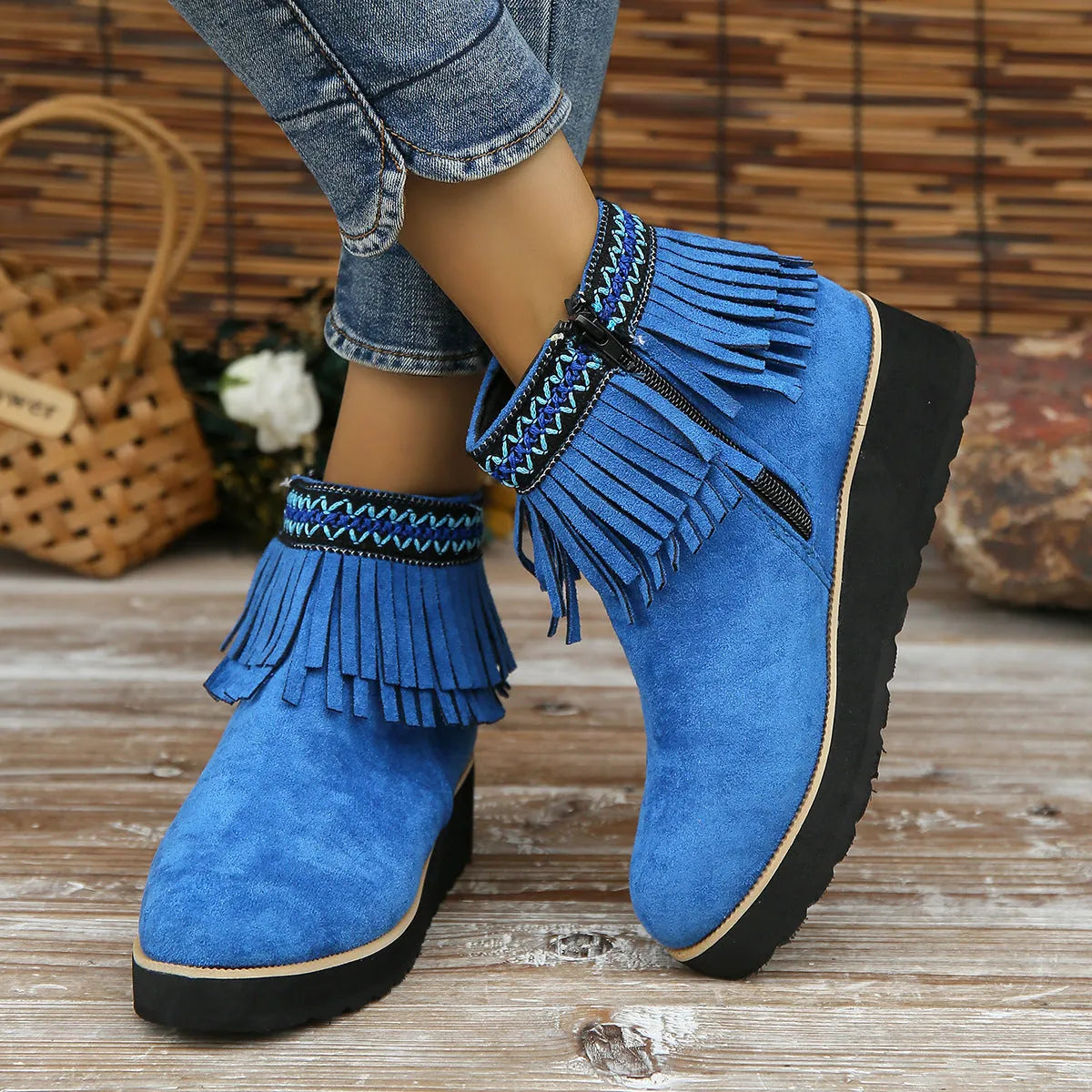 Women's black suede wedge ankle boots with side zipper, tassel detail, and thick rubber sole.