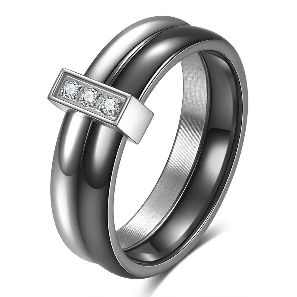Geometric ceramic women's ring with zirconium inlay and glossy stitching in steel black.
