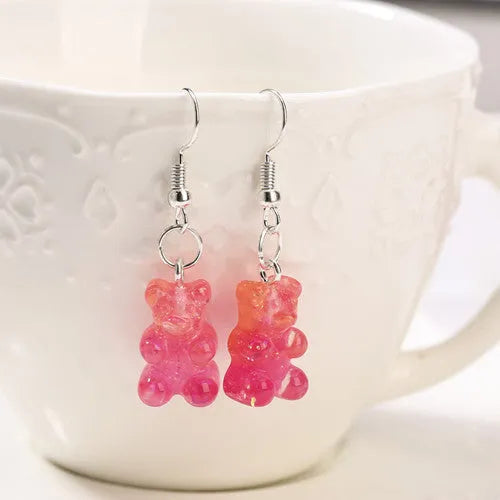 Resin cartoon glitter two-tone earrings in silver blue showing pendants with sparkle finish