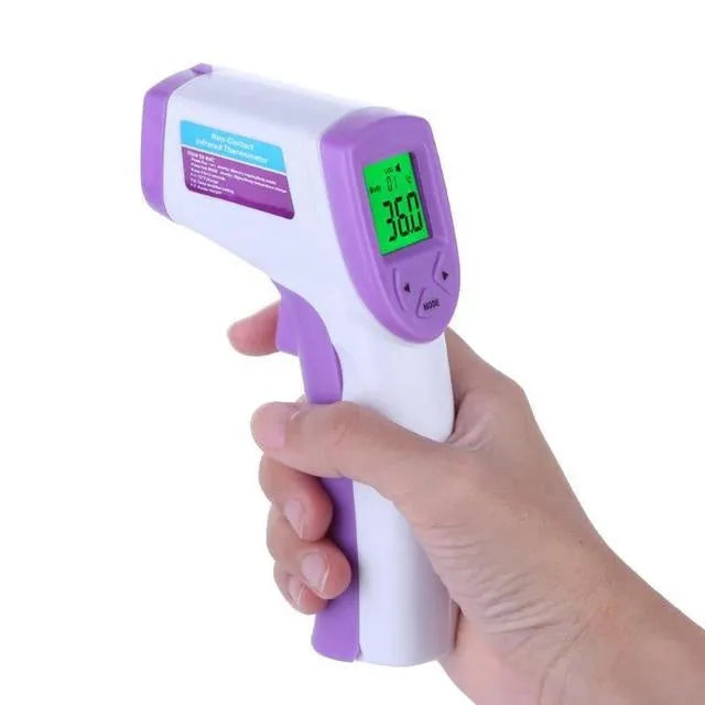 White PK58B non-contact infrared thermometer held near adult forehead with LCD screen showing temperature