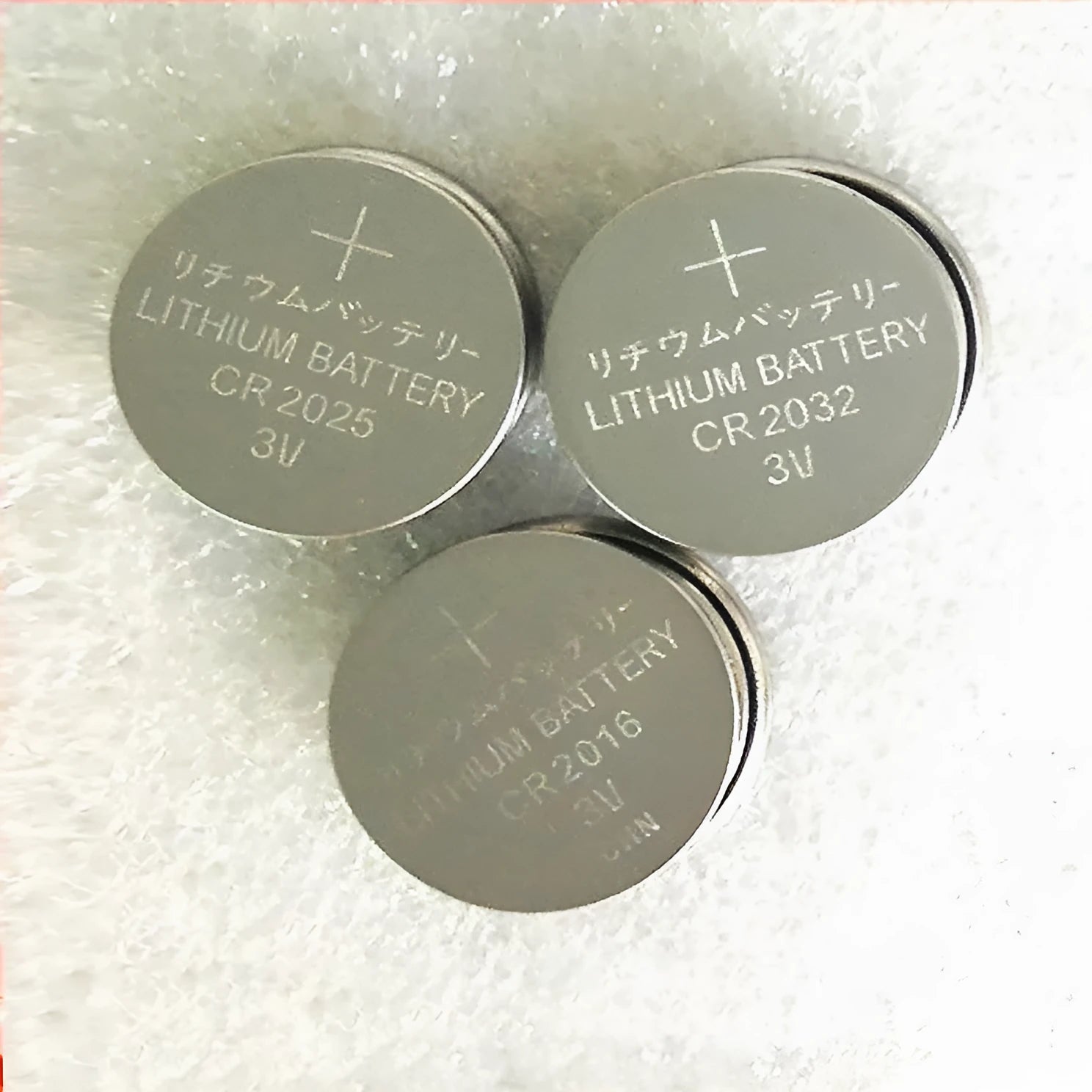 Three alkaline button batteries showing CR2032, CR2025, and CR2016 models with 20mm diameter.