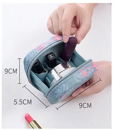 Blue cloth cube-shaped makeup storage bag on a table.