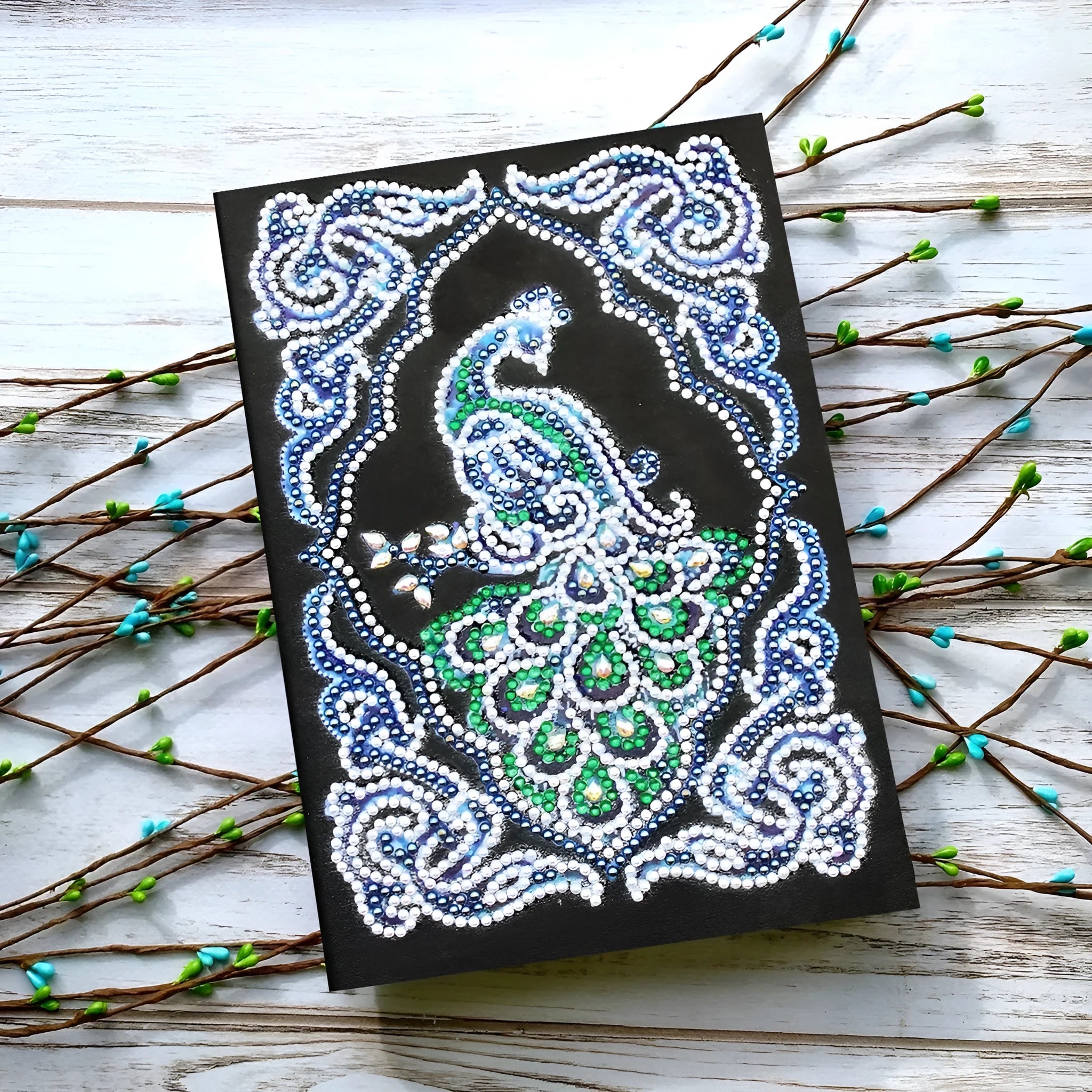 Black A5 diamond painting notebook with a peacock design, shaped drills, and OPP packaging.