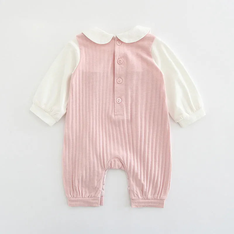 Pink baby girls embroidered jumpsuit with long sleeves and a single-breasted closure.