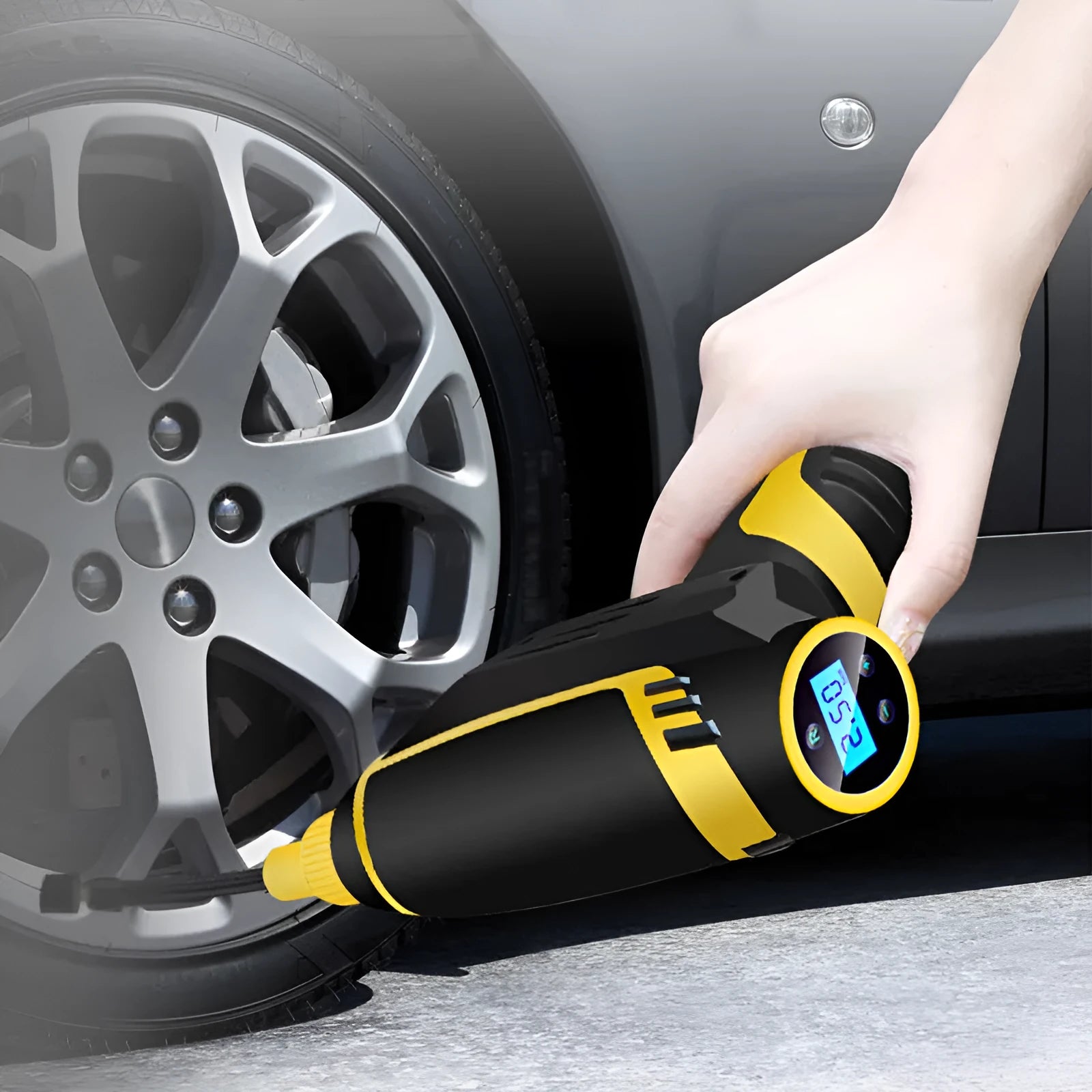Automatic portable handheld digital LED car air compressor with hose and connectors on black background