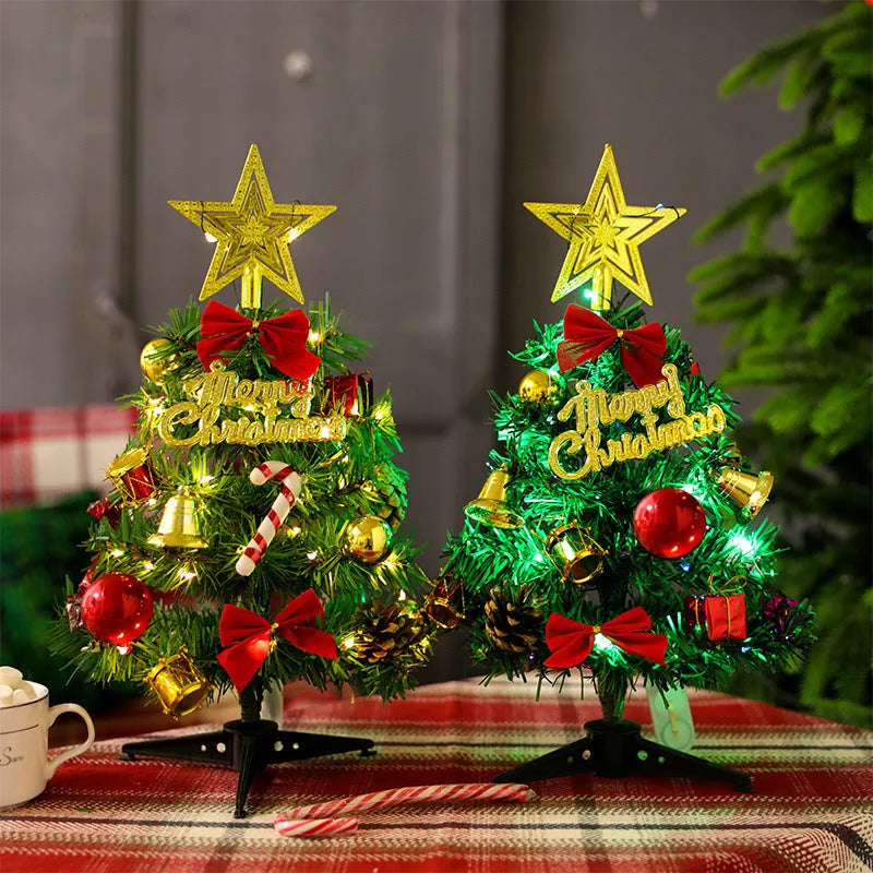 Mini Christmas tree 30cm tall in PVC, colour A, on a tabletop with festive background