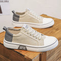 Men's low top casual canvas shoes in blue with round toe and front lace-up, on a plain background.