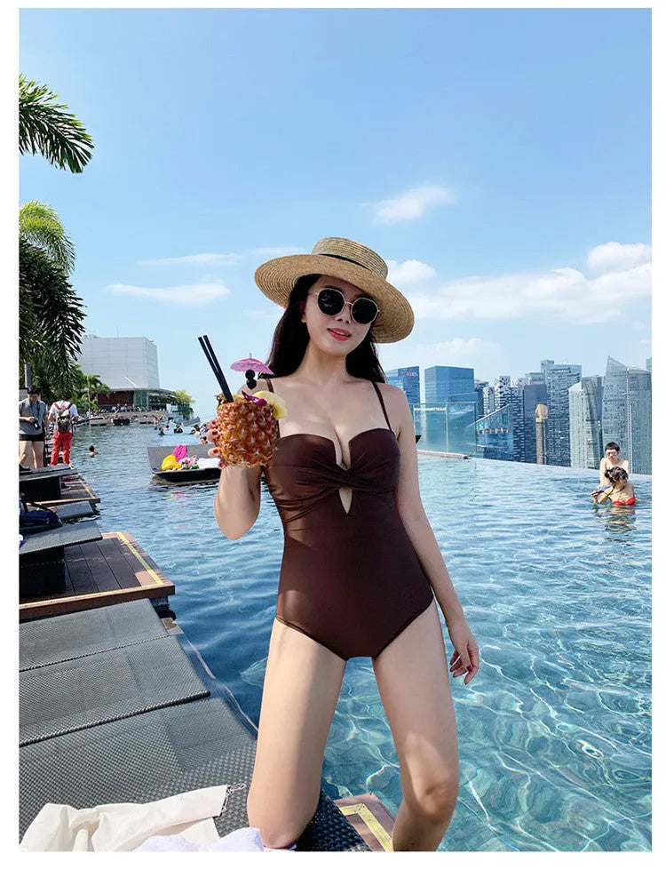 Brown women's one-piece swimsuit with spaghetti straps and push-up bust on a mannequin.