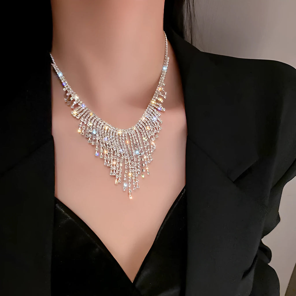 Silver alloy diamond tassel necklace with geometric pendant and ball bead chain on a woman