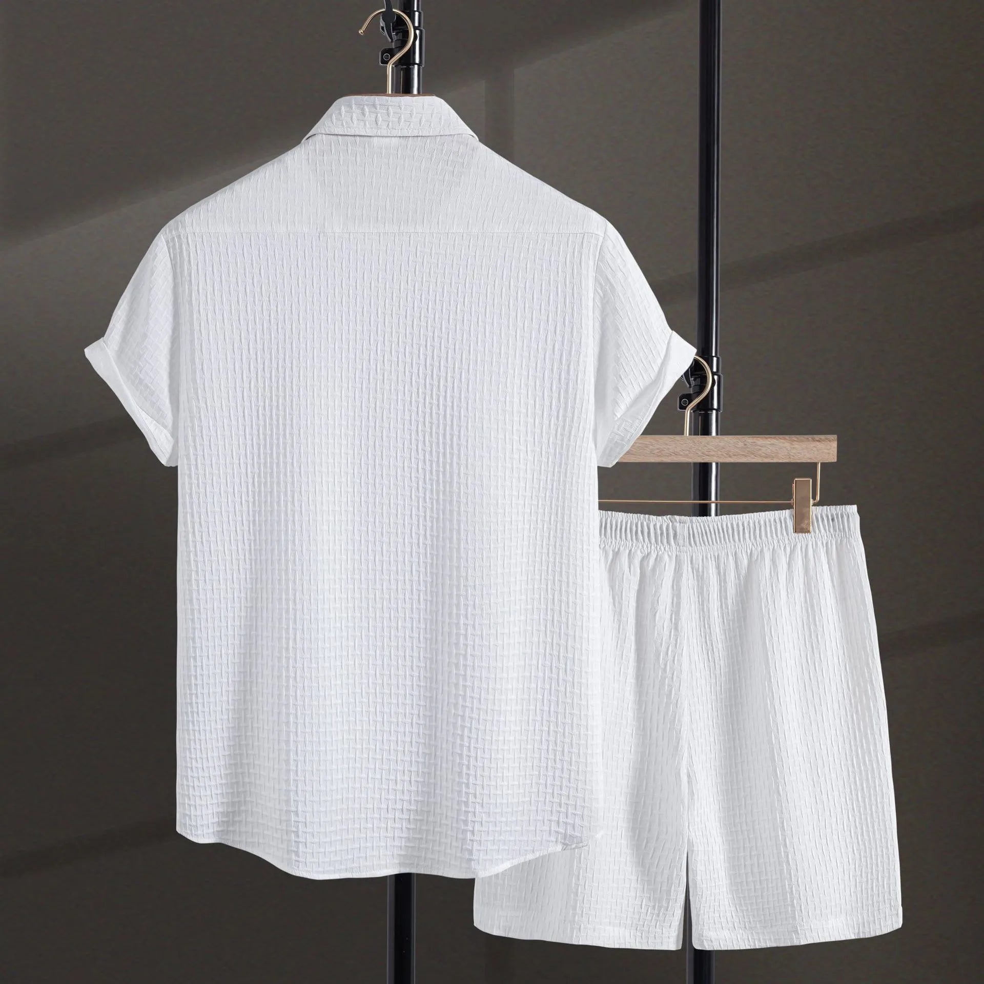 Men's black cotton blend short sleeve shirt and shorts beach suit laid flat.
