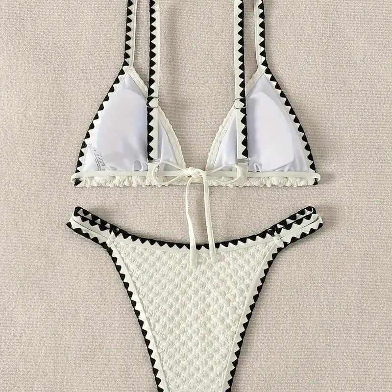 Women's blue and white polyester bikini swimsuit set with briefs style on hanger.