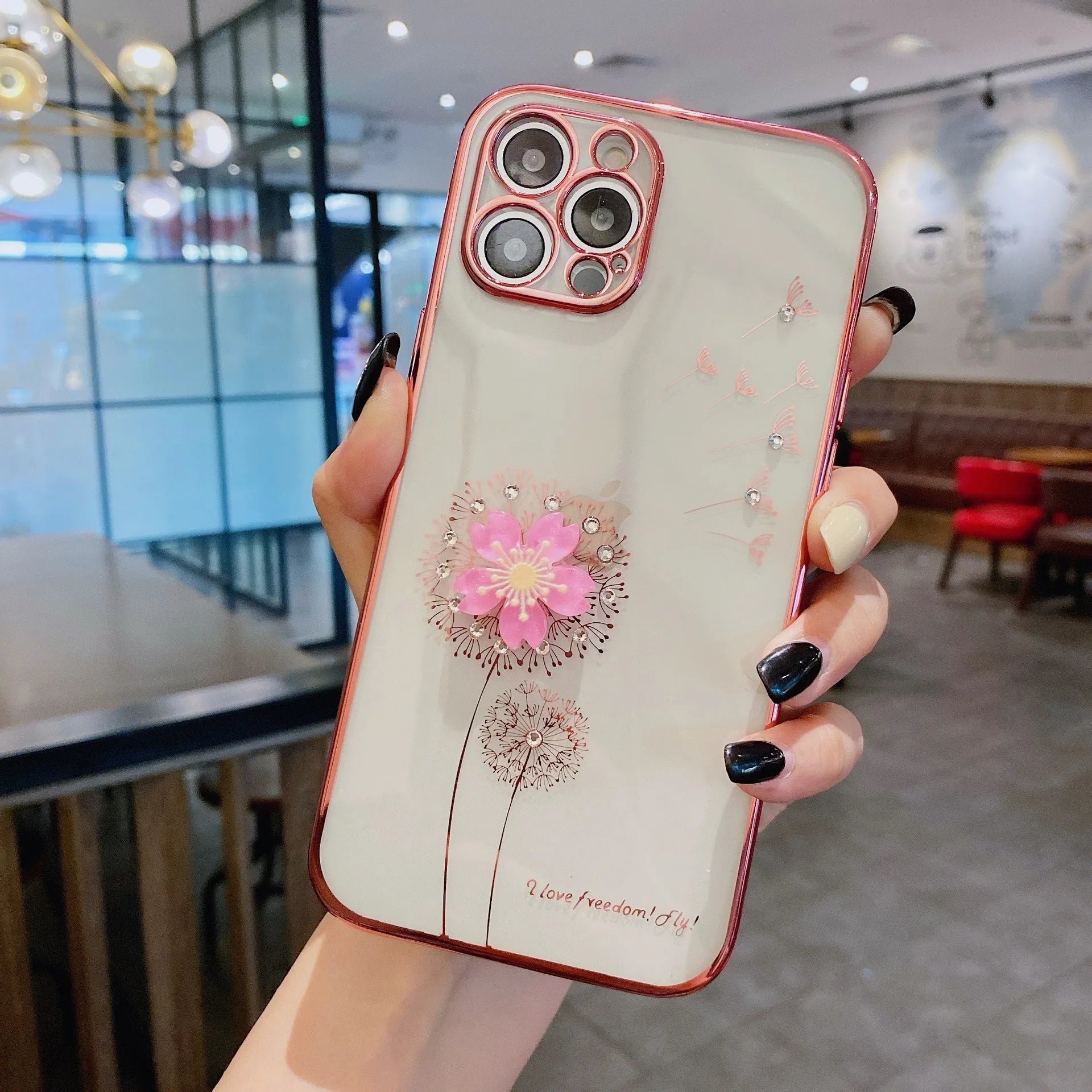 Green iPhone case with a 3D white flower spin stand on the back, showing the built-in screen protector.