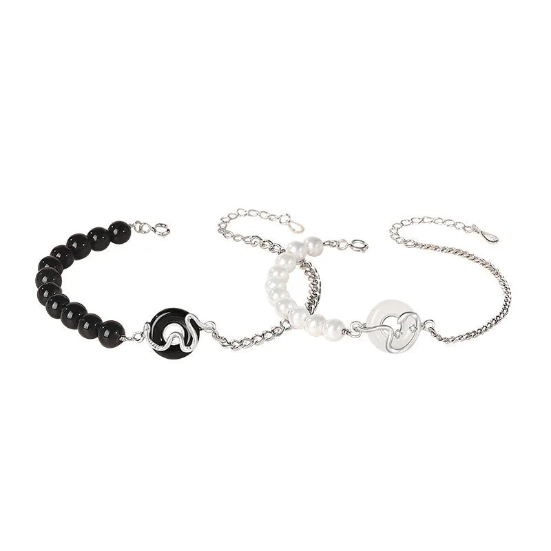 A New Chinese style 925 sterling silver couple's bracelet with a safe buckle, snake motif, and a central obsidian pearl.