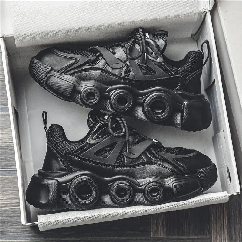 Men's black low-top sneakers with mesh upper, thick rubber sole, and round toe lace-up design.