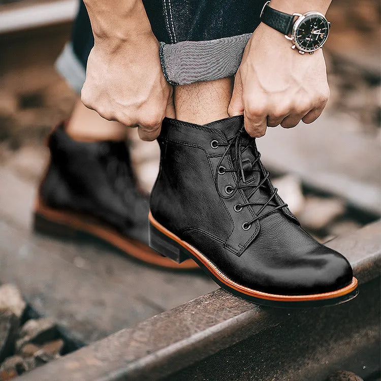 Men's black military Martin boots with rubber sole and lace-up closure on a work site