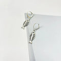A pair of retro-style alloy earrings with a fishbone pendant hanging from an O-shaped chain.