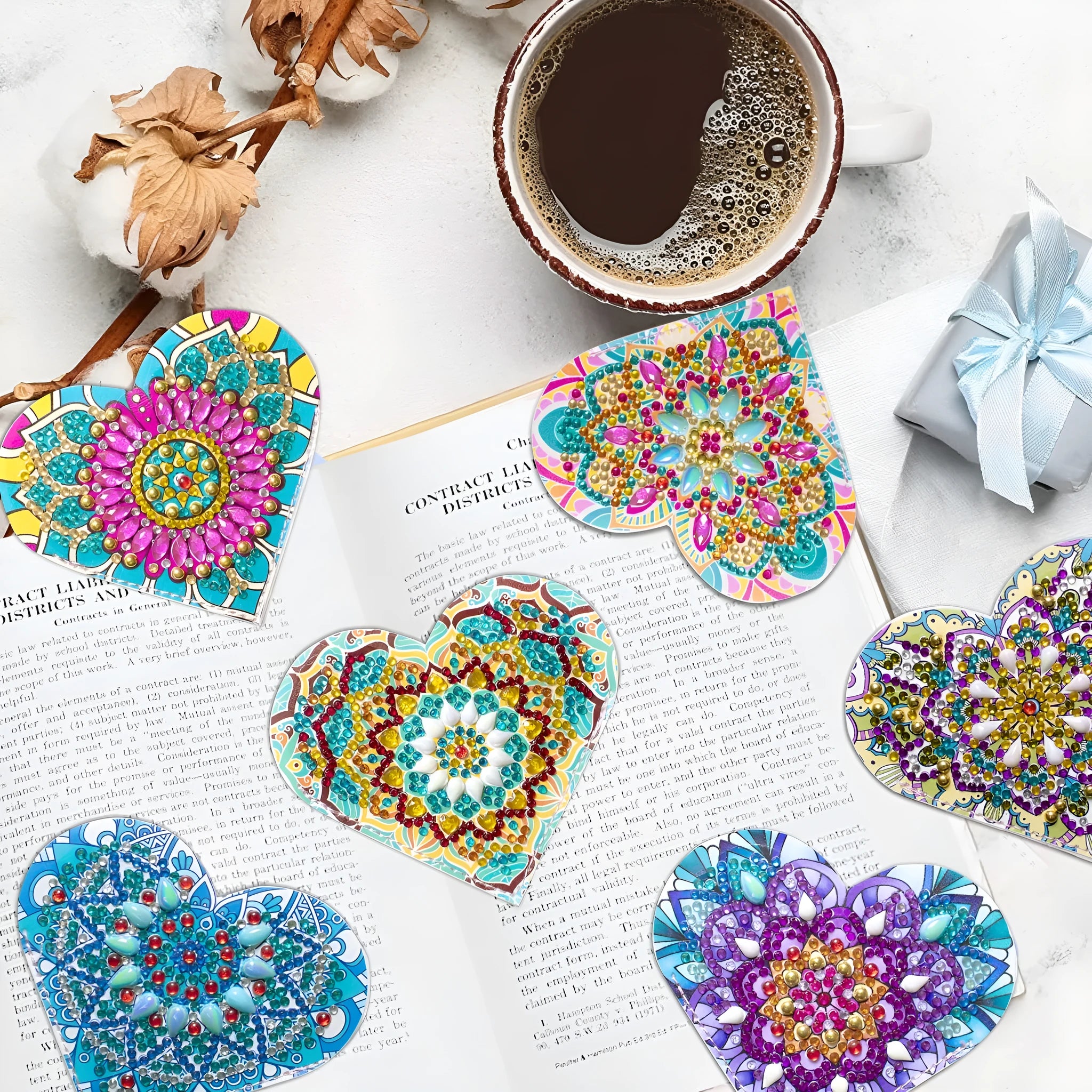 Set of six handmade PU leather flower cornerite bookmarks with stick-on crystals on a surface.