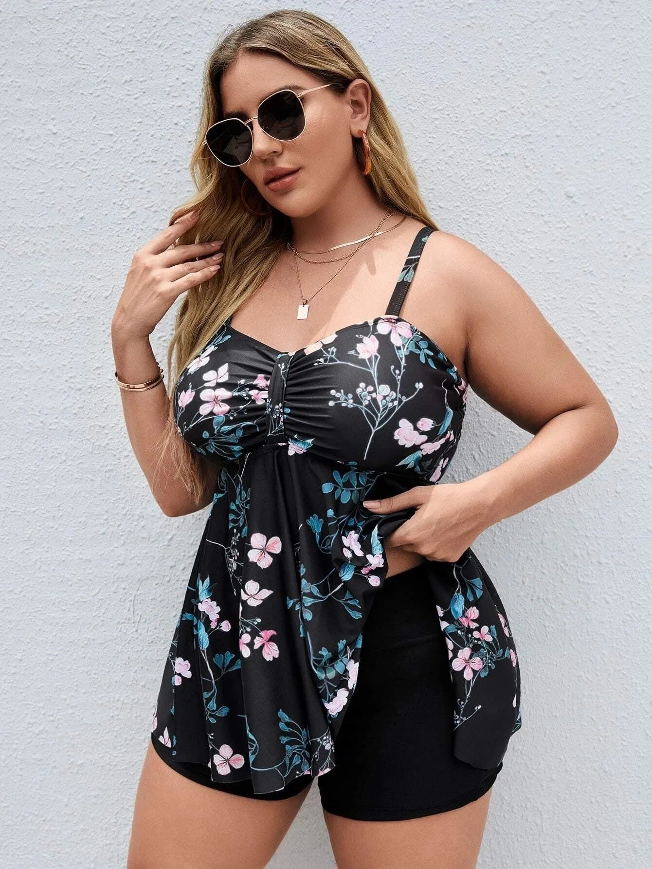 Women's floral print one-piece swimsuit with split colours, shown on a model.