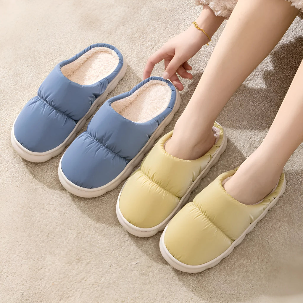 A pair of thick-soled down cotton slippers for men and women in a choice of colours, featuring a non-slip rubber sole.