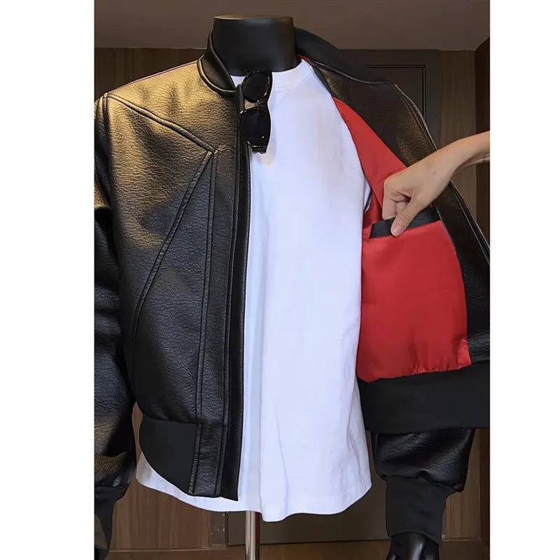 Men's long black slim-fit PU leather jacket with litchi grain texture on a hanger.