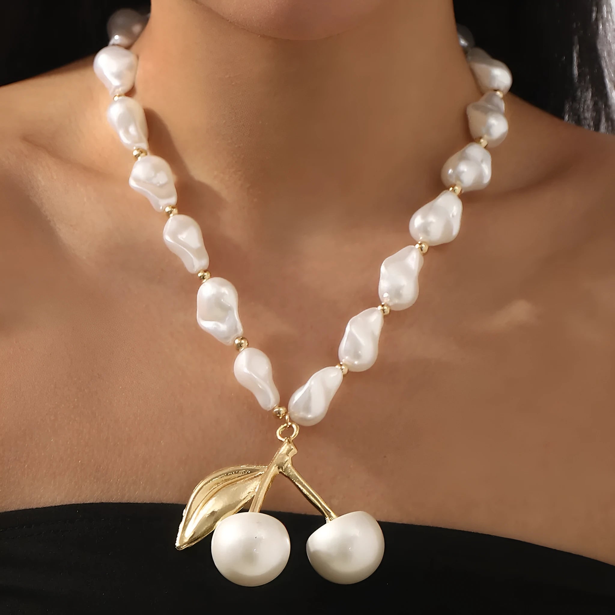 Gold and pearl fruit geometric necklace for women on a white background