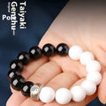 Black and white obsidian tai chi bracelet with 10mm geometric beads and bodhi mantra design