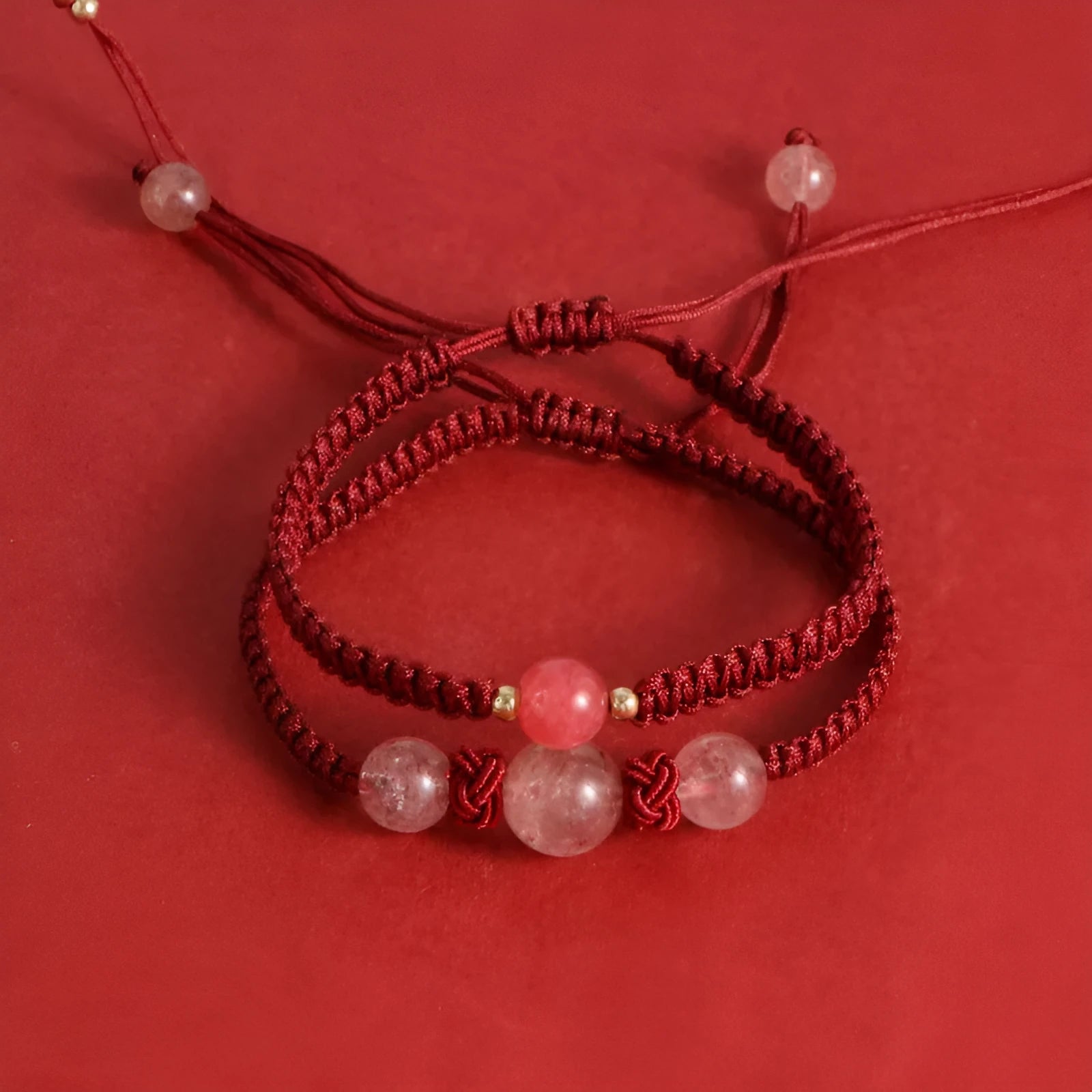 Woven rope bracelet with spherical strawberry quartz beads and alloy accents
