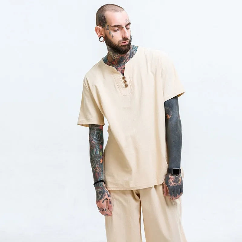 Man wearing a loose grey cotton and linen short-sleeve T-shirt, casual fit.