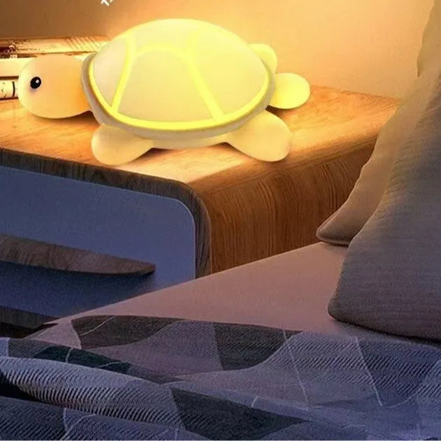 Cute turtle silicone USB rechargeable night light on a bedside table, soft glow, low voltage