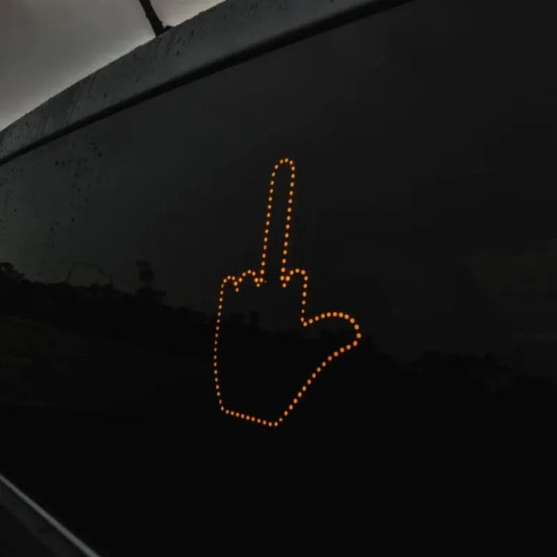 Black LED gesture car light with amber illumination showing hand gesture, remote control, and 3M Velcro mounting