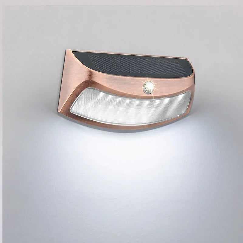 Solar outdoor wall light with smiling face design for garden decoration