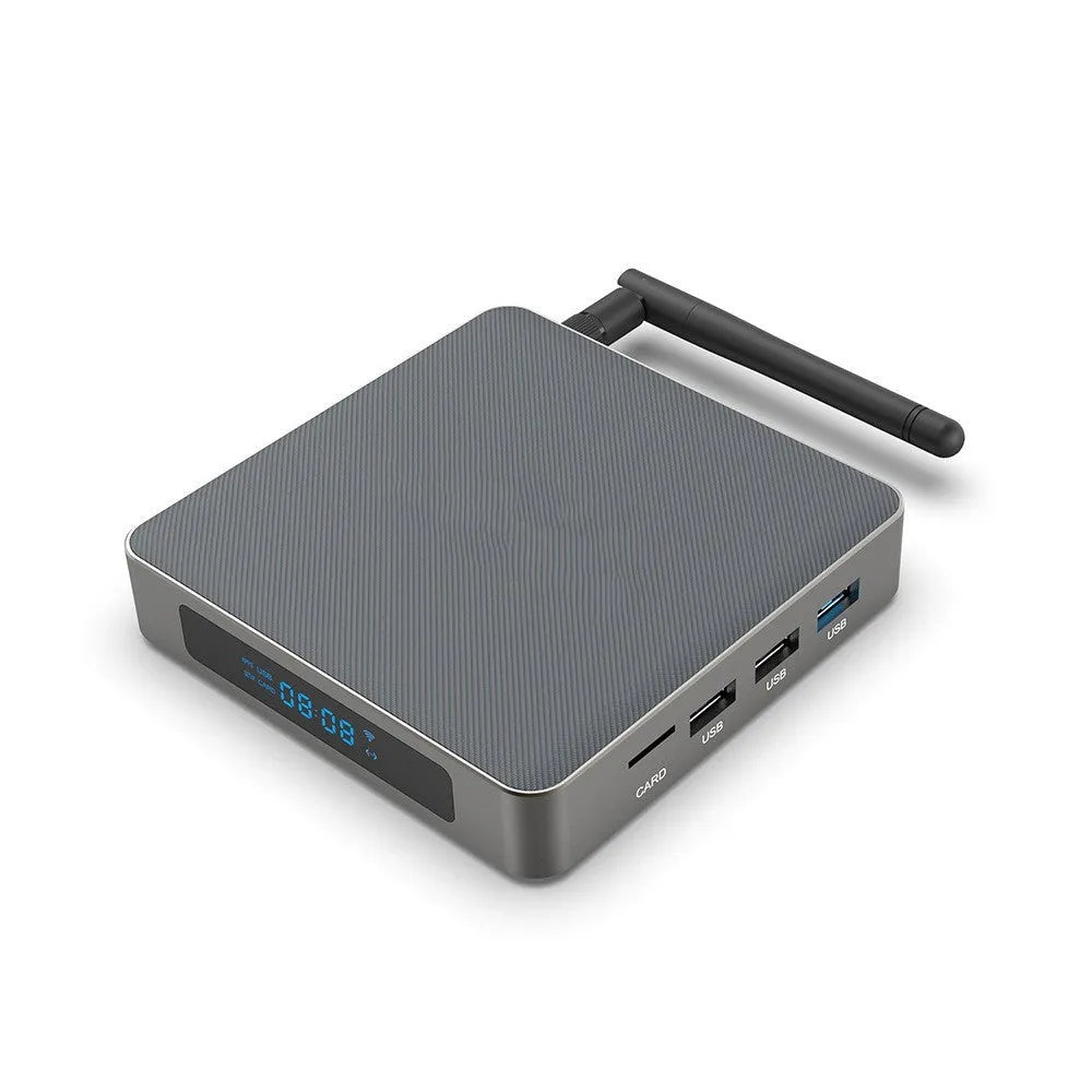 Black Android TV set-top box with HDMI port and remote control on a wooden surface.