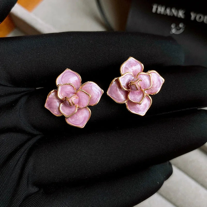 Gold plated purple oil-spot glaze flower stud earrings on a copper base.