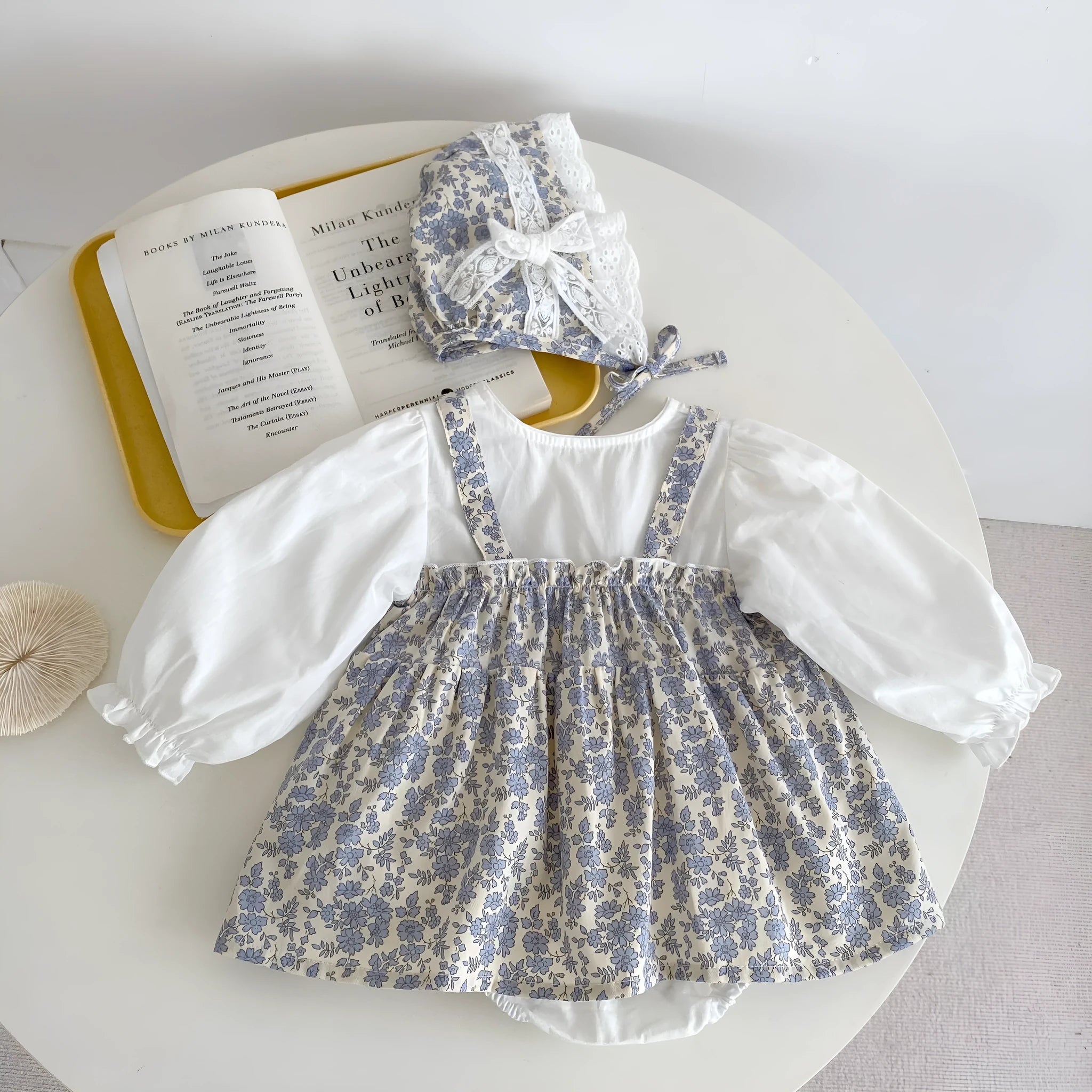 White cotton baby girl floral princess fake two triangle romper with removable hood, long sleeves, front view