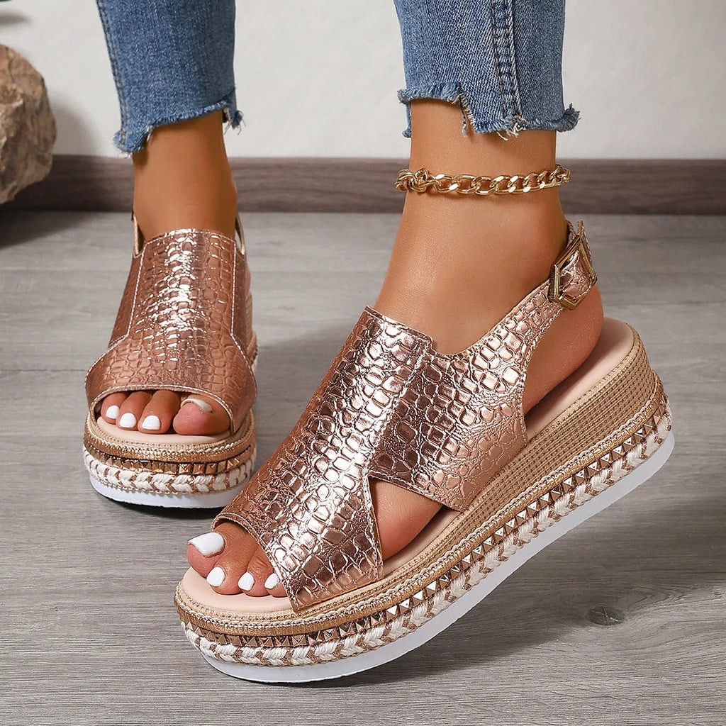 Gold women's Roman sandals with round hollow-out toe and an ankle buckle strap on a rubber sole.