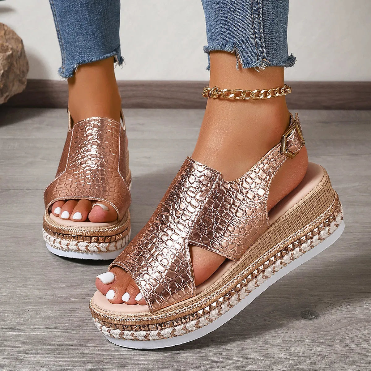 Gold women's Roman sandals with round hollow-out toe and an ankle buckle strap on a rubber sole.