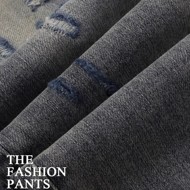 Men's slim fit jeans with embroidered patches and worn wash effect in old colour