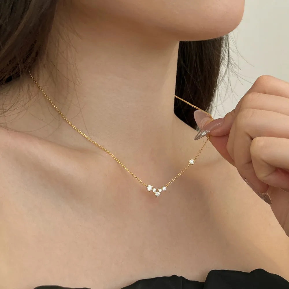 925 silver clavicle chain necklace with geometric pendant in electroplated gold finish on a woman's neck