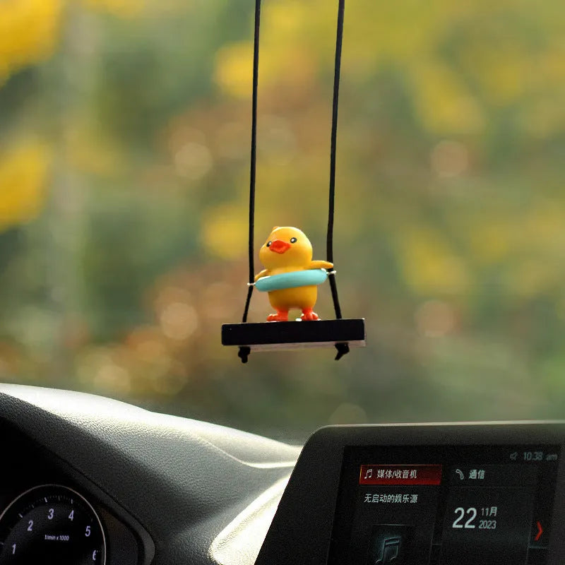 Cute little yellow plastic duck doll car hanging ornament in cartoon style.