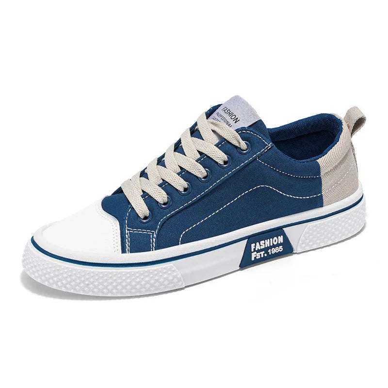 Men's low top casual canvas shoes in blue with round toe and front lace-up, on a plain background.
