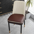 Orange leather horseshoe-shaped seat cushion on a wooden dining chair.