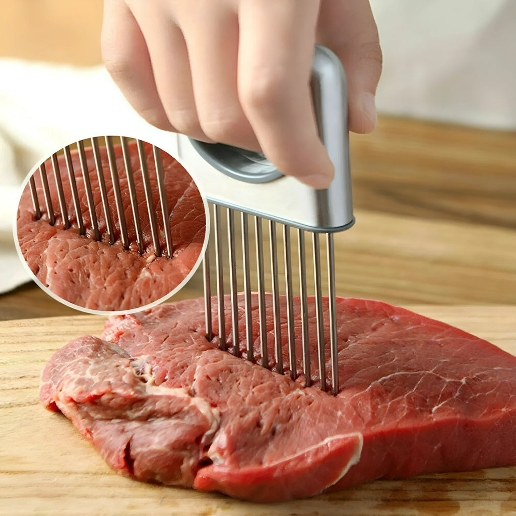 Stainless steel onion holder slicer with sharp prongs and a red finger guard on a cutting board.
