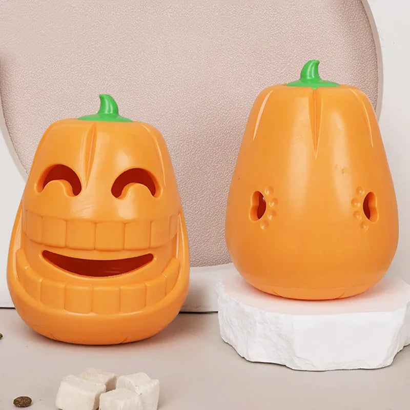 Orange Halloween pumpkin shaped durable thermoplastic rubber dog chew toy with a treat-dispensing funnel.